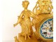 Gilded clock with Sèvres porcelain plaques, elegant woman, 19th century library